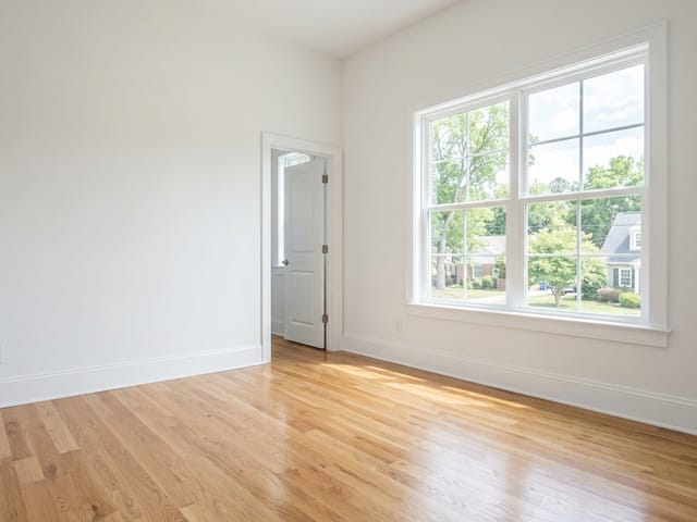 Finished wood flooring in a bright empty room
